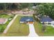 Aerial view of the property showcases its well-manicured lawn and desirable neighborhood setting at 13803 Se 44Th Ave, Summerfield, FL 34491