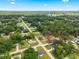A lovely aerial view of a well-maintained neighborhood with lush greenery, blue skies and a home with beautiful landscaping at 13803 Se 44Th Ave, Summerfield, FL 34491