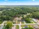 The aerial view captures the property's location near a wooded area and quiet neighborhood setting at 13803 Se 44Th Ave, Summerfield, FL 34491