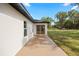 Covered patio area with double doors, perfect for outdoor living and entertaining at 13803 Se 44Th Ave, Summerfield, FL 34491