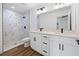 Stylish bathroom features double vanity, sleek black hardware, and walk-in shower at 13803 Se 44Th Ave, Summerfield, FL 34491