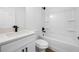 Bathroom features modern fixtures, a shower and tub combo, and laminate flooring at 13803 Se 44Th Ave, Summerfield, FL 34491