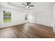 Bedroom offers abundant light with a neutral color palette and wood-look flooring at 13803 Se 44Th Ave, Summerfield, FL 34491
