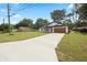 Charming single-story home featuring a spacious driveway, beautiful lawn, and inviting craftsman accents at 13803 Se 44Th Ave, Summerfield, FL 34491