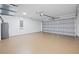 Spacious two car garage with an epoxy floor and garage door opener at 13803 Se 44Th Ave, Summerfield, FL 34491