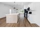 Bright kitchen showcasing an island with pendant lighting and modern white cabinetry and black appliances at 13803 Se 44Th Ave, Summerfield, FL 34491