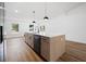Kitchen island with quartz countertops, a dishwasher, and modern pendant lighting above at 13803 Se 44Th Ave, Summerfield, FL 34491