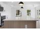 Close-up of the kitchen island with stone counter and pendant lighting above sink, ready for entertaining at 13803 Se 44Th Ave, Summerfield, FL 34491