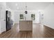 Open kitchen with an island and stainless steel appliances, seamlessly flowing into the living space at 13803 Se 44Th Ave, Summerfield, FL 34491
