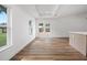 An airy living room features lots of natural light and double doors leading outside at 13803 Se 44Th Ave, Summerfield, FL 34491