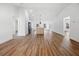 Spacious, open layout connecting living area to kitchen with a light color scheme and wood-look flooring at 13803 Se 44Th Ave, Summerfield, FL 34491