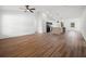 Open floor plan with wood-look floors connecting the living room and kitchen area with island at 13803 Se 44Th Ave, Summerfield, FL 34491