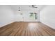 Bright living room featuring new floors, ceiling fan, and a large window for natural light at 13803 Se 44Th Ave, Summerfield, FL 34491