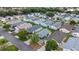 Neighborhood aerial showcases lush greenery, mature trees, and well-spaced homes at 1405 Espinoza Ln, Lady Lake, FL 32159
