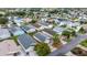 Aerial view of community with home outlined in red, mature trees, and well-kept landscaping at 1405 Espinoza Ln, Lady Lake, FL 32159