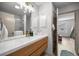This modern bathroom features a wood vanity, sleek fixtures, and a shower at 1405 Espinoza Ln, Lady Lake, FL 32159