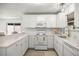 Charming kitchen with white cabinets, modern appliances, and ample counter space at 1405 Espinoza Ln, Lady Lake, FL 32159
