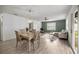 Bright living and dining area with wood-look floors, modern lighting, and stylish furnishings at 1405 Espinoza Ln, Lady Lake, FL 32159