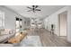 Spacious living room with wood-look floors, a dining area, and sliding glass doors to the lanai at 1405 Espinoza Ln, Lady Lake, FL 32159