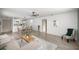 Spacious and bright living area with wood-look floors, a dining area, and easy access to the kitchen at 1405 Espinoza Ln, Lady Lake, FL 32159
