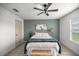 This calming bedroom has a ceiling fan, natural light, and green accent wall at 1405 Espinoza Ln, Lady Lake, FL 32159