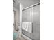Well-lit shower with glass doors and chrome fixtures, adjacent to the toilet at 1405 Espinoza Ln, Lady Lake, FL 32159