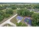 An aerial view of a lovely home nestled among mature trees, set back from a quiet, country road at 14650 Sw 33Rd Ln, Ocala, FL 34481