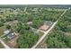An aerial shot displays a neighborhood with tree-lined streets and well-spaced homes at 14650 Sw 33Rd Ln, Ocala, FL 34481