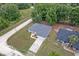 An aerial view showcasing a well-maintained home with mature landscaping and a large driveway at 14650 Sw 33Rd Ln, Ocala, FL 34481