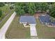 An aerial of a charming home with a long driveway surrounded by a beautifully landscaped yard in a serene neighborhood at 14650 Sw 33Rd Ln, Ocala, FL 34481