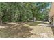Large backyard featuring ample green space, a fire pit, and a concrete patio, great for outdoor activities at 14650 Sw 33Rd Ln, Ocala, FL 34481