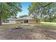 Expansive backyard featuring a brick fire pit and a cozy patio perfect for outdoor entertainment at 14650 Sw 33Rd Ln, Ocala, FL 34481