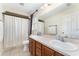 Bathroom features a double sink vanity and shower with a neutral color palette and decor at 14650 Sw 33Rd Ln, Ocala, FL 34481