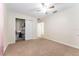Bedroom with carpet flooring features a ceiling fan and a closet with sliding doors at 14650 Sw 33Rd Ln, Ocala, FL 34481