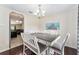 Bright dining room features a gray wood table, seating for five, and modern light fixture at 14650 Sw 33Rd Ln, Ocala, FL 34481