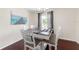 Bright dining room features a gray wood table, seating for five, and patterned curtains at 14650 Sw 33Rd Ln, Ocala, FL 34481