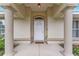 Inviting front entrance with decorative columns, and a charming white door with glass window at 14650 Sw 33Rd Ln, Ocala, FL 34481