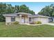 Charming single-story home featuring a well-manicured lawn and classic architectural details at 14650 Sw 33Rd Ln, Ocala, FL 34481