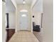 Inviting foyer showcasing tile flooring, view of the front door and a glimpse of living area at 14650 Sw 33Rd Ln, Ocala, FL 34481