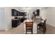 Well-lit kitchen features dark cabinets and a breakfast bar with seating at 14650 Sw 33Rd Ln, Ocala, FL 34481