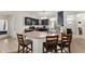 Open kitchen with breakfast bar, offering stainless appliances, dark cabinets, and easy access to other living spaces at 14650 Sw 33Rd Ln, Ocala, FL 34481