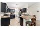 Functional kitchen with tile floors, stainless steel appliances, and dark cabinetry at 14650 Sw 33Rd Ln, Ocala, FL 34481