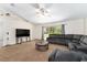 Bright living room with large sectional sofa and sliding glass doors at 14650 Sw 33Rd Ln, Ocala, FL 34481