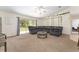 Bright living room with large sectional sofa and sliding glass doors at 14650 Sw 33Rd Ln, Ocala, FL 34481