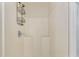 Shower stall has a shower head, shelves, and a neutral color palette at 14650 Sw 33Rd Ln, Ocala, FL 34481