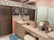 Bathroom features a vanity with sink, vanity table, shower, and large mirror at 1815 Puerto Bello Dr, The Villages, FL 32159