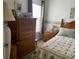 Cozy bedroom with natural light, dresser, and a comfortable bed at 1815 Puerto Bello Dr, The Villages, FL 32159