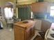 Spacious kitchen with an island, wooden cabinets, and tile backsplash at 1815 Puerto Bello Dr, The Villages, FL 32159