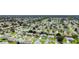 Overhead view of a housing community with manicured yards and trees at 1819 Captiva Ct, The Villages, FL 32162