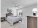 Serene bedroom featuring neutral tones, tiled flooring, and a ceiling fan at 1819 Captiva Ct, The Villages, FL 32162